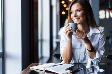 woman drinking coffee in the morning at restaurant