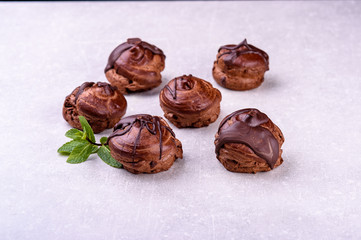  chocolate eclairs on a gray background in the kitchen4