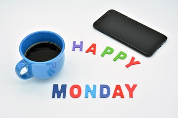 Feliz lunes, hecho con letras de colores, y una taza azul  de café
