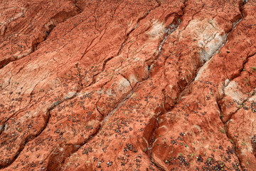 Aerial view of dried out red clay dirt with cracks in clay quarry.