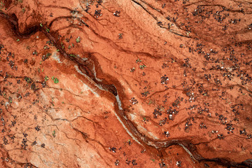 Aerial view of dried out red clay dirt with cracks in clay quarry.