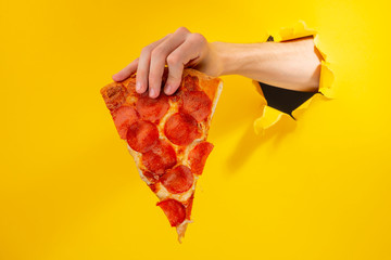 Hand giving a pizza slice