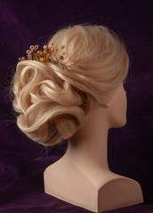 evening hairstyle on the head of a mannequin
