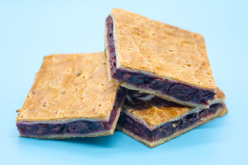 sour cherry pie on blue background breakfast concept