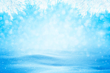 Natural sunny snow drifts background with shades, snowy branches and falling snow.