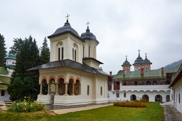 Fototapeta na wymiar Sinaia Monastery, located in Sinaia, in Prahova County, Romania. Stone religious building of Christian Orthodox church built in the Byzantine style.