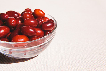 Red cornel berries in glass bowl with copy space, healthy food