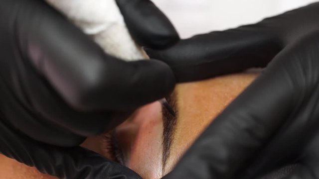professional eyebrow tattoo from a qualified master. cosmetic procedure with a special apparatus