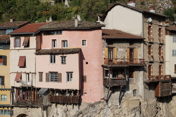 old stone colorful houses with hanging decks  above the river in France