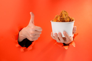 Hand holding cup of nuggets