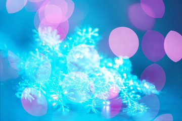 New Year's abstraction in the form of multi-colored bokeh on a blue background. Festive mood.