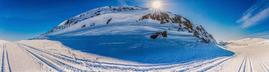Panorama view at Atoklinten Mountain in Lappland, Northern Sweden, side view. All snowmobiles drive...