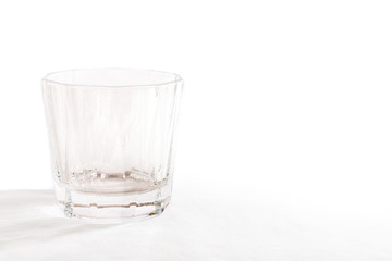 A single glass tumbler on a white background