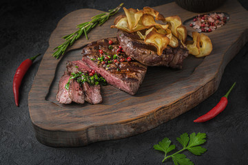 Grilled beek steak on wooden board, close view