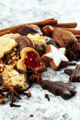 christmas cookies with spieses, nuts and fruits on rustic table