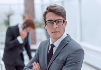 successful business man standing in a modern office.