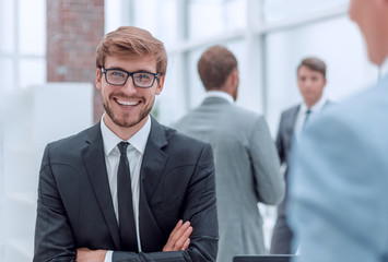 smiling young businessman at the workplace office.