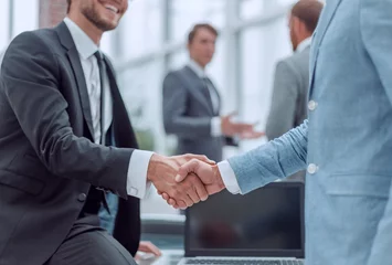 Foto op Plexiglas happy young businessman shaking hands with his business partner © ASDF