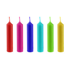 Christmas candles in different color. They are decorative candles. It's a set of xmas candles in red, purple, blue, green and yellow