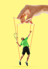 Man like a puppet in somebodies hands on yellow background. Concept of unfair manipulation,...