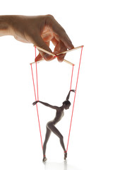 Woman like a puppet in somebodies hands on white background. Concept of unfair manipulation,...