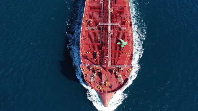 Aerial drone video of industrial oil and fuel tanker cruising deep blue Mediterranean sea