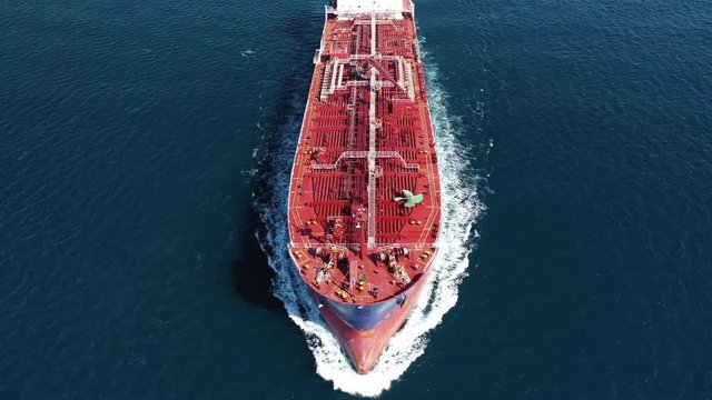 Aerial drone video of industrial oil and fuel tanker cruising deep blue Mediterranean sea