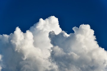 White, puffy clouds against a blue sky