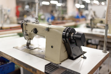 Industrial sewing machine in the work shop. Shoe manufacturing.