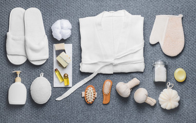 Clean bathrobe with spa supplies on plaid