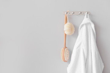 Clean bathrobe hanging on wall in room