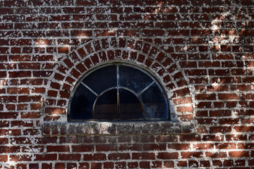 Old window in an old brick house. Old architecture. Grunge window