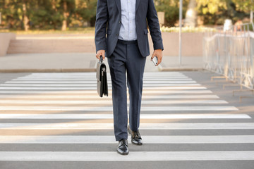 Handsome businessman on pedestrian crosswalk