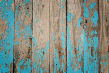 Old shabby light blue wood texture with peeled paint.