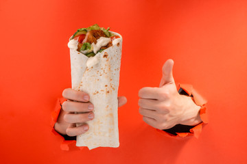 Hand holding a doner