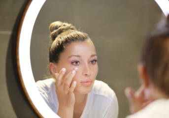 Magic anti-aging cream.Applying the cream