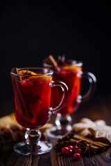 Winter holidays celebration, warming mood, cozy home concept. Two glasses of mulled wine with orange slices at Christmas time.