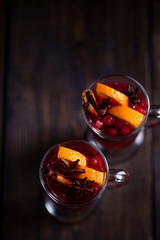 Two glasses of mulled wine with orange slices at Christmas time. Warming drink, cozy home weekend atmosphere