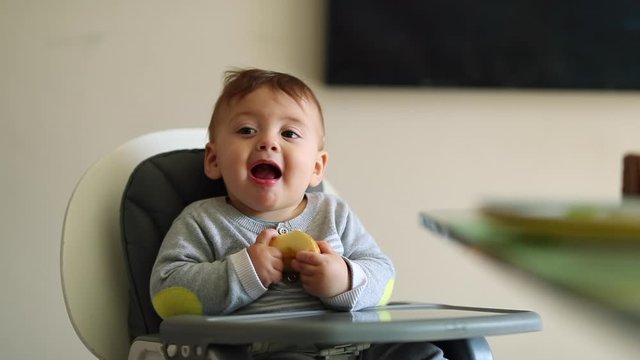 Baby gagging while eating piece of apple open mouth
