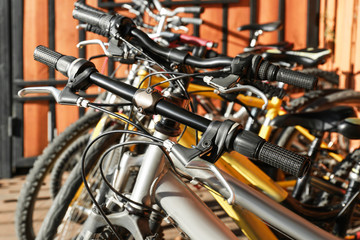 Fototapeta na wymiar Many modern bicycles parked outdoors, closeup