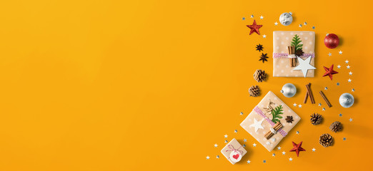 Handmade Christmas gift boxes with ornaments - flat lay