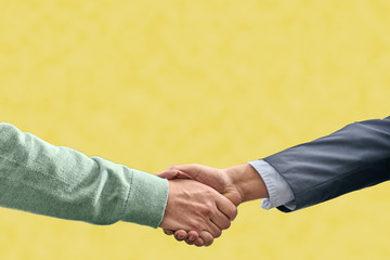 handshake on yellow background verbal agreement concept