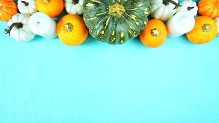 Happy Thanksgiving setting modern elegant blue orange and white themed table with pumpkins...