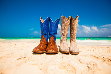 A Pair of Cowboy Boots left on the beach on a tropical vacation