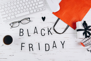 Black Friday board on a white wooden table, top view