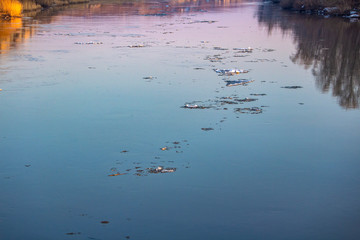 spring ice drift on the river in muddy water before high water and flood, front and background blurred with bokeh effect