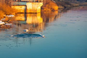 spring ice drift on the river in muddy water before high water and flood, front and background blurred with bokeh effect