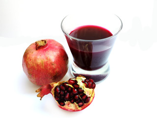 Glass of pomegranate juice and pomegranate fruit