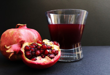 Glass of pomegranate juice and pomegranate fruit