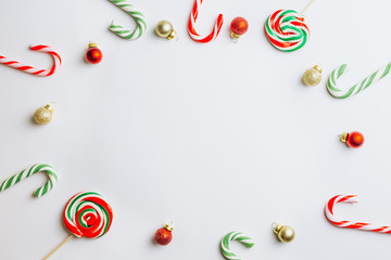 Christmas balls, candy cane and place for text on white background, Christmas planning concept. Flat lay. Top view